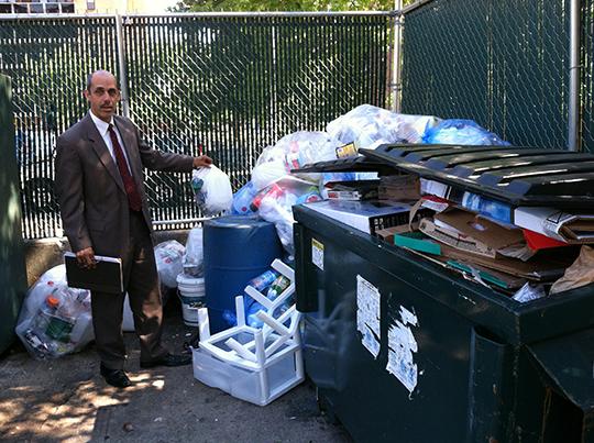 Jamie Towers General Manager, Victor Berrios, stands with the growing piles of recycling.